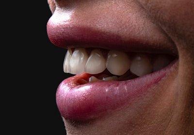 a person's mouth with teeth and tongue sticking out