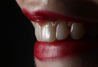 person with red lipstick and white pearl earrings