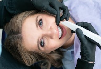 a woman is smiling while holding a toothbrush