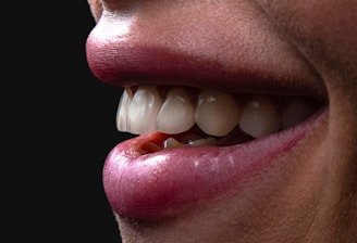 a person's mouth with teeth and tongue sticking out