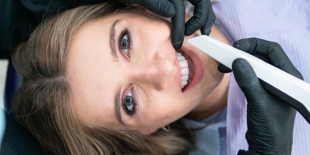 a woman is smiling while holding a toothbrush